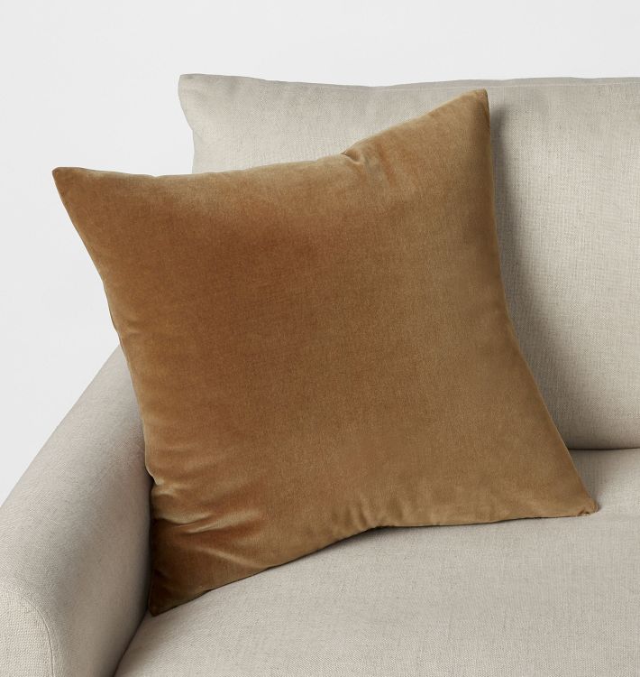 Square camel velvet pillow cover shown on an ivory chair